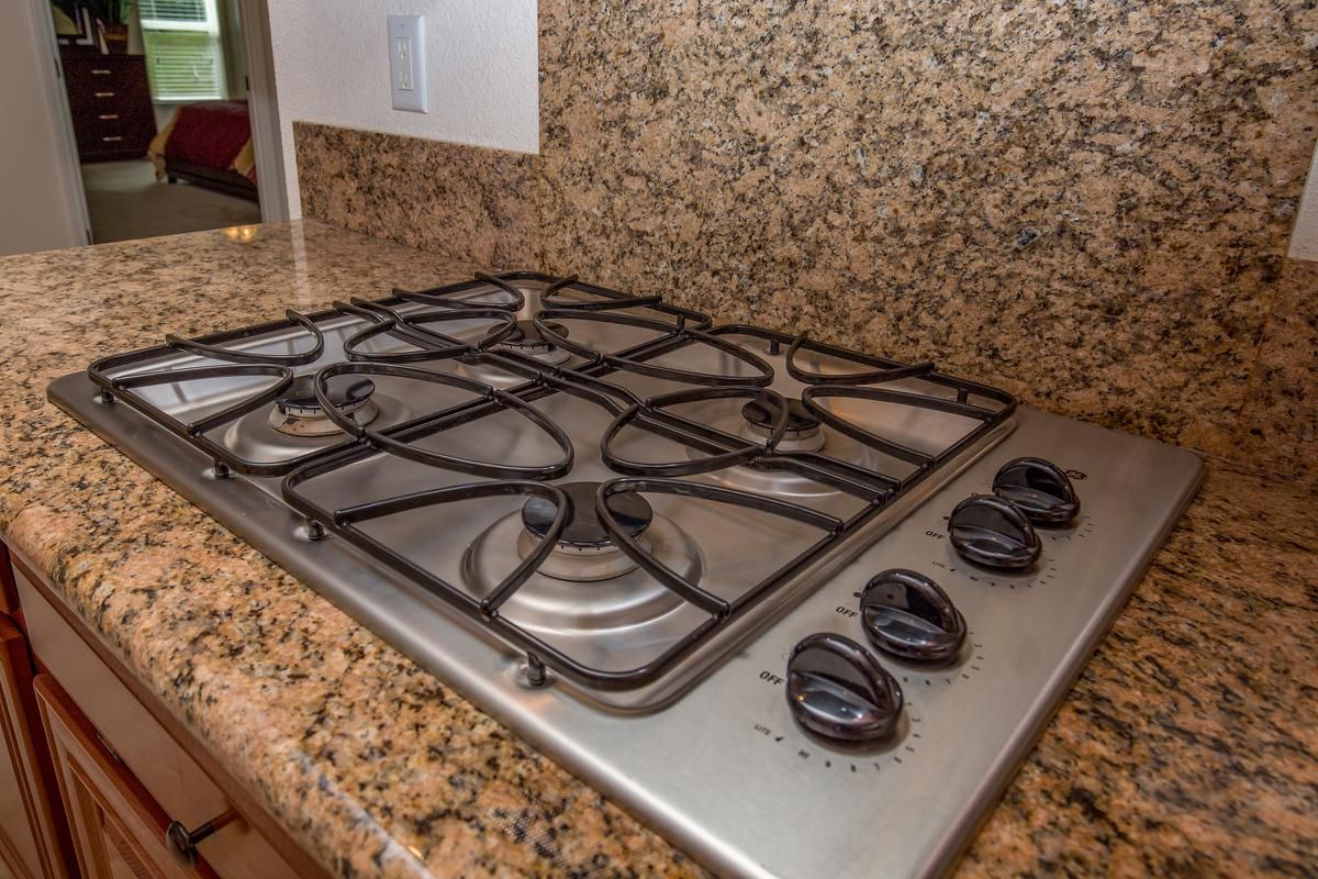 a stove top oven sitting inside of a kitchen