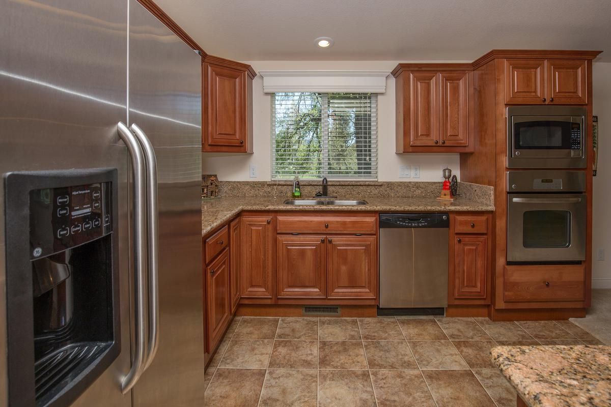 a kitchen with stainless steel appliances and wooden cabinets