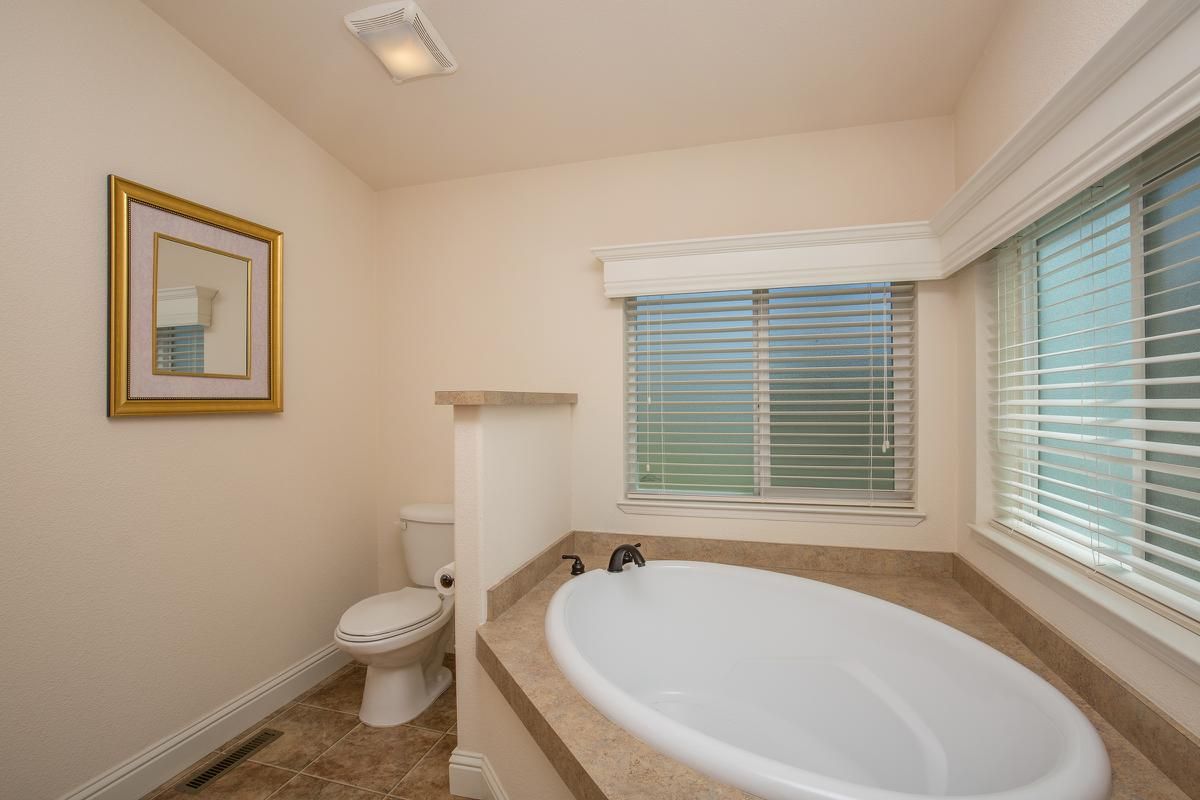 a white sink sitting under a window