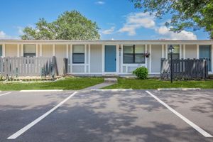 an empty parking lot in front of a house