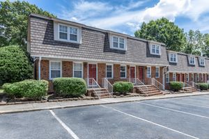 an empty parking lot in front of a house