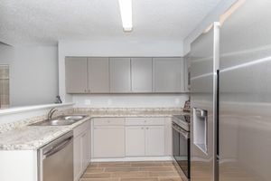 a kitchen with a sink and a refrigerator