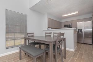 a kitchen with a table and chairs in a room