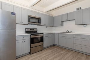 a kitchen with wooden cabinets