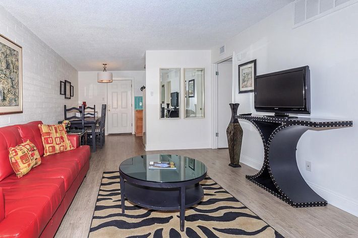 a living room filled with furniture and a flat screen tv