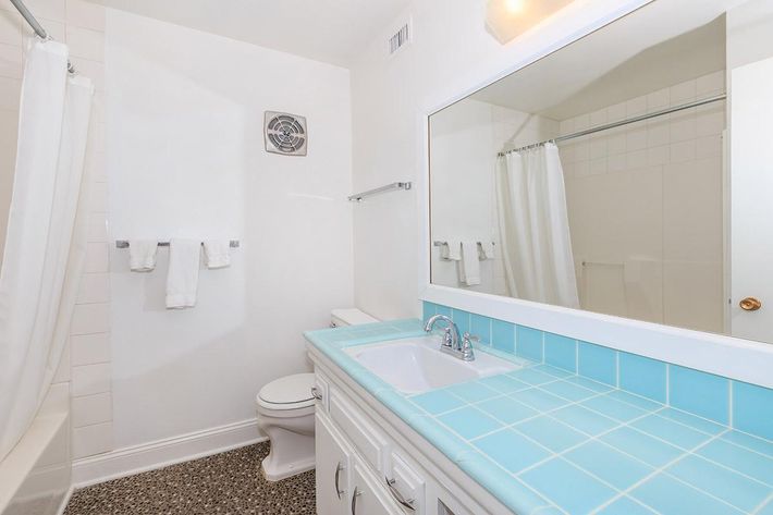 a large white tub next to a sink