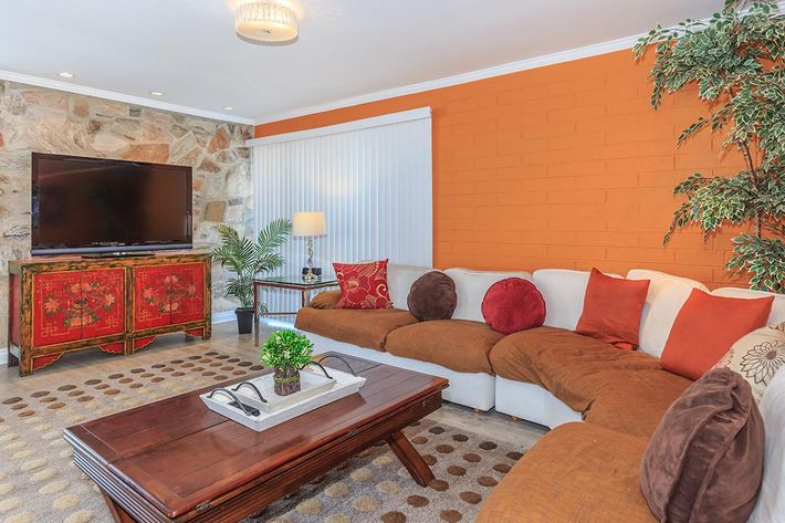 a living room filled with furniture and a fire place