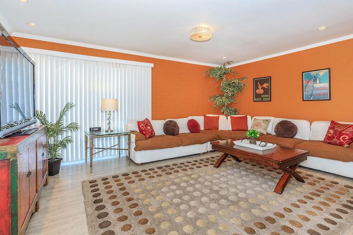 a living room filled with furniture and a flat screen tv