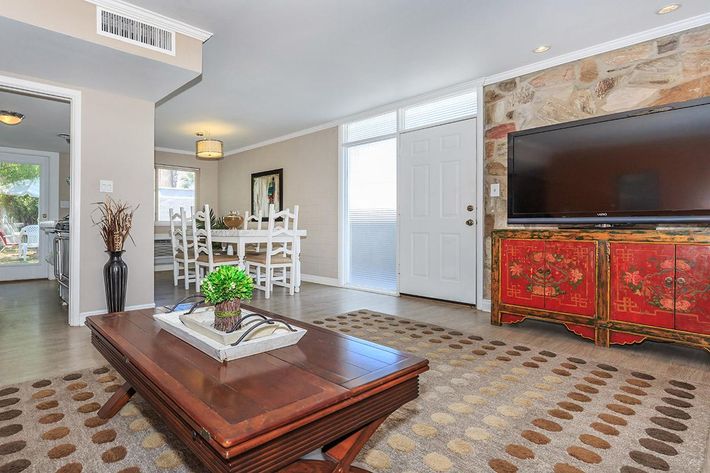 a living room filled with furniture and a flat screen tv