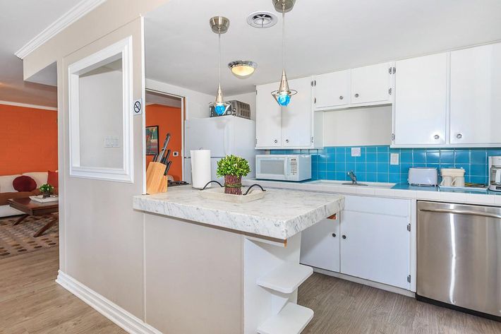 a kitchen with a sink and a refrigerator