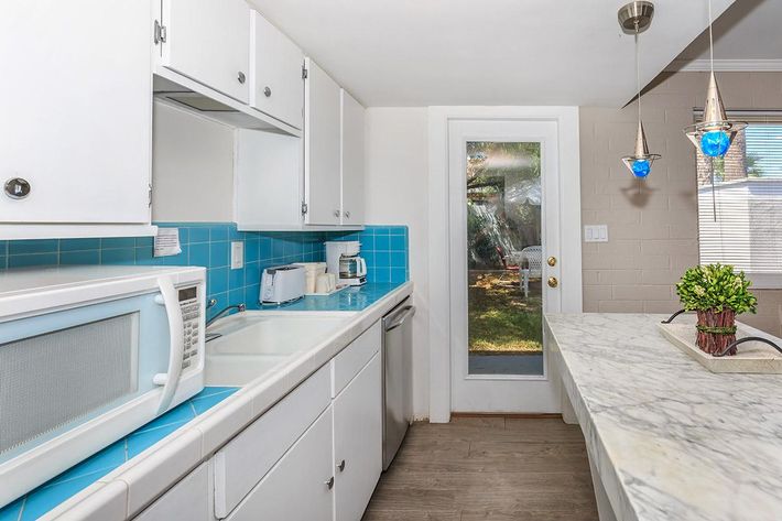 a kitchen with a sink and a microwave