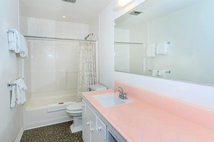 a large white tub next to a sink