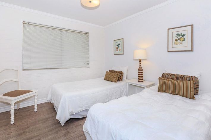 a bedroom with a bed and desk in a room