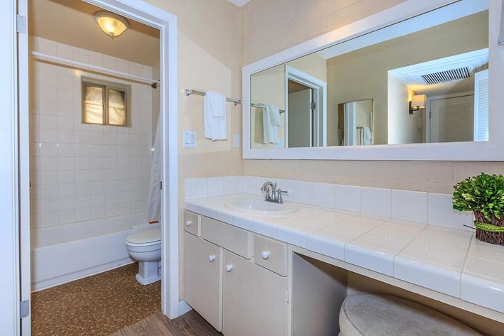a large white tub next to a window