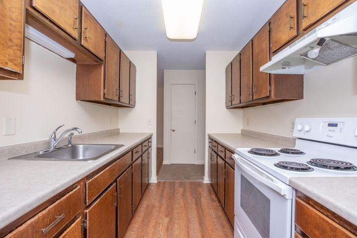 a kitchen with a stove a sink and a microwave