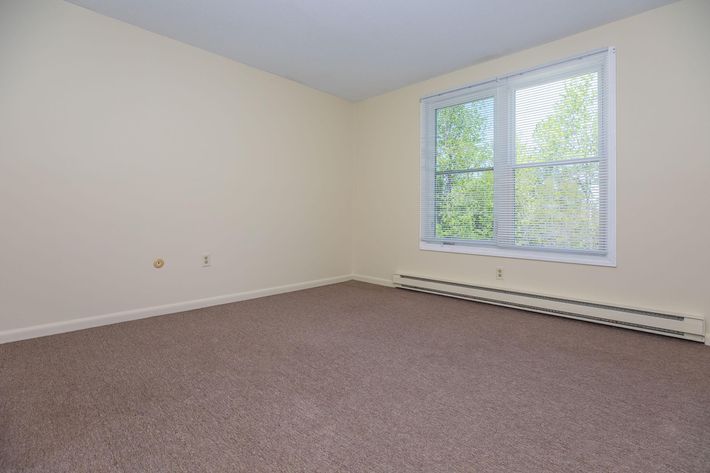 a bedroom with a large window