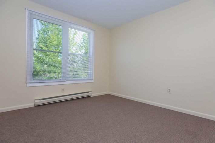 a bedroom with a large window