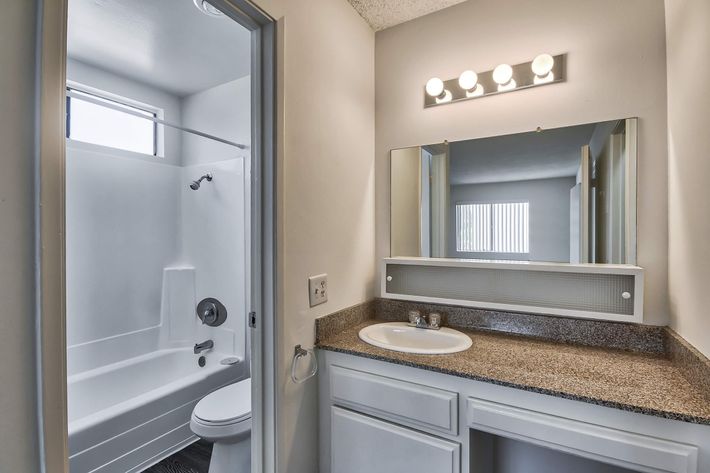Bathroom sink with open vacant bathroom door