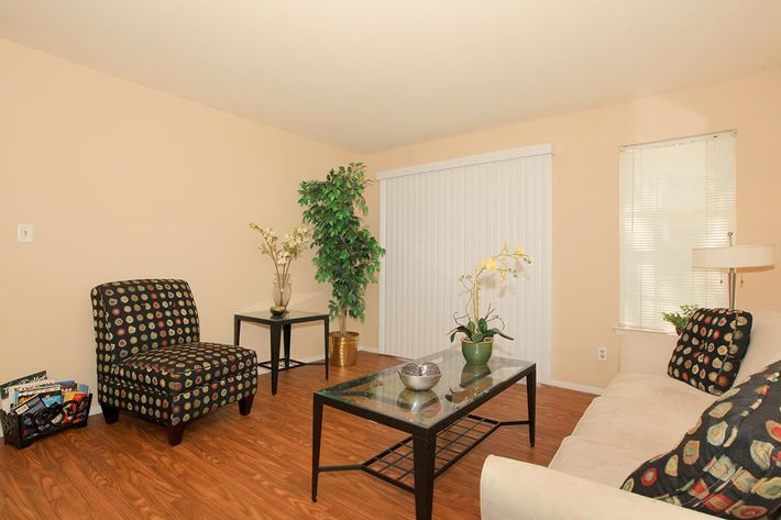 a living room filled with furniture and a flat screen tv