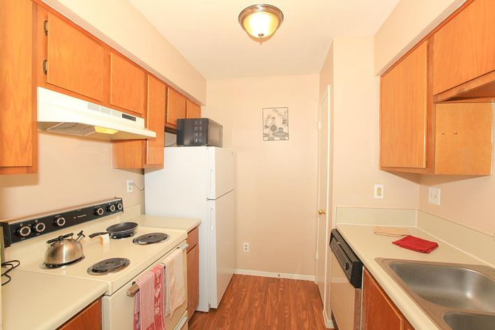 a kitchen with a stove top oven sitting inside of a refrigerator