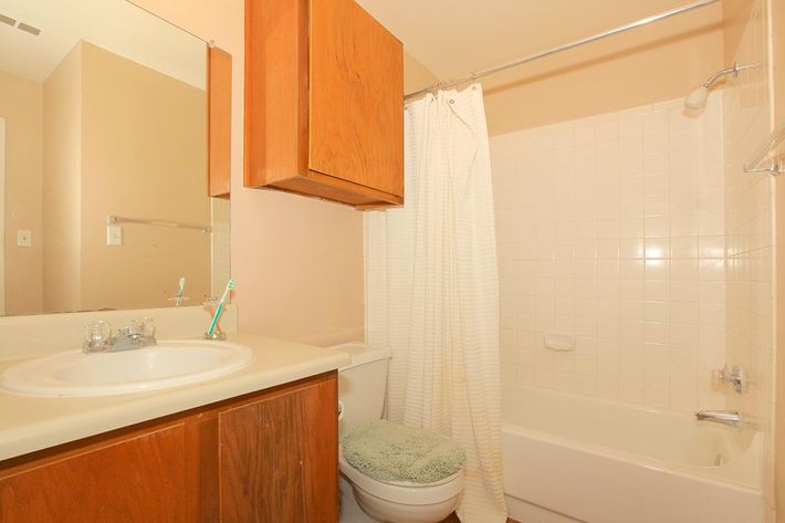 a white tub sitting next to a sink