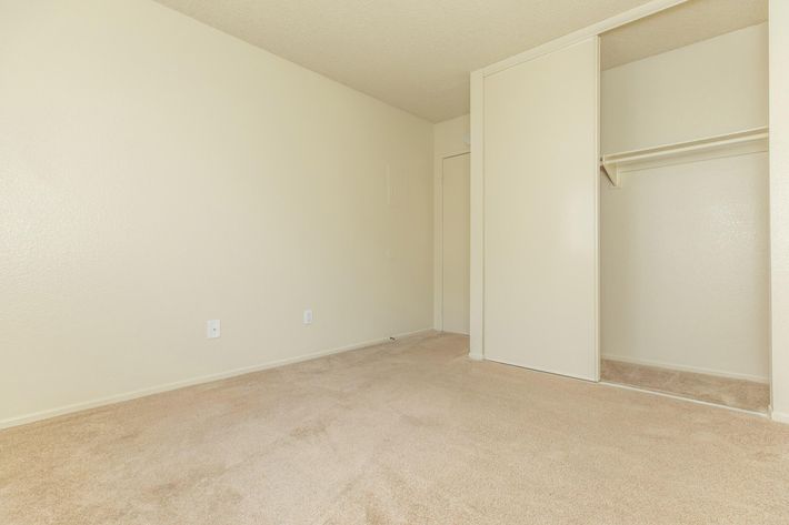 Bedroom with open sliding closet door