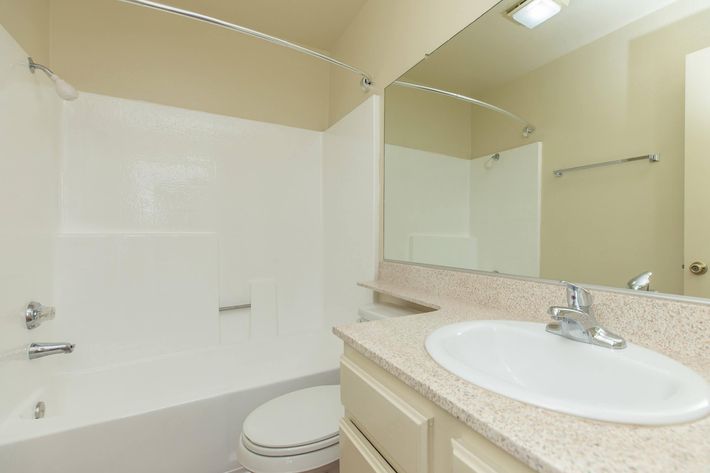 Unfurnished bathroom with white cabinets