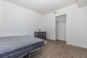 a bedroom with a bed in a room