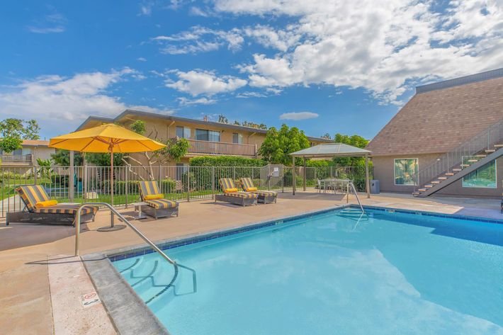 Vio Tustin community pool with yellow chairs