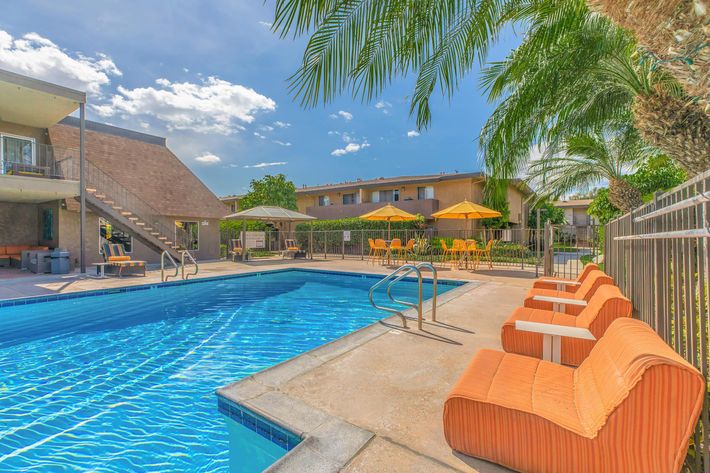 Orange chairs next to the community pool