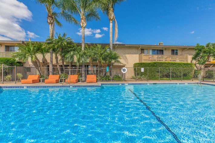 The community pool with orange chairs