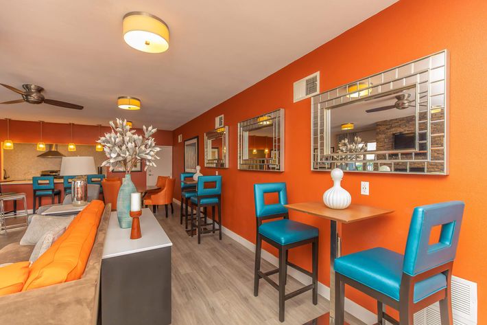 Tables and teal chairs in the community room