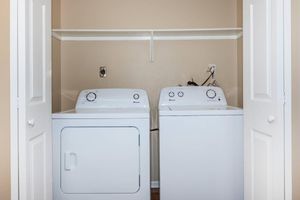 a white refrigerator freezer sitting next to a door