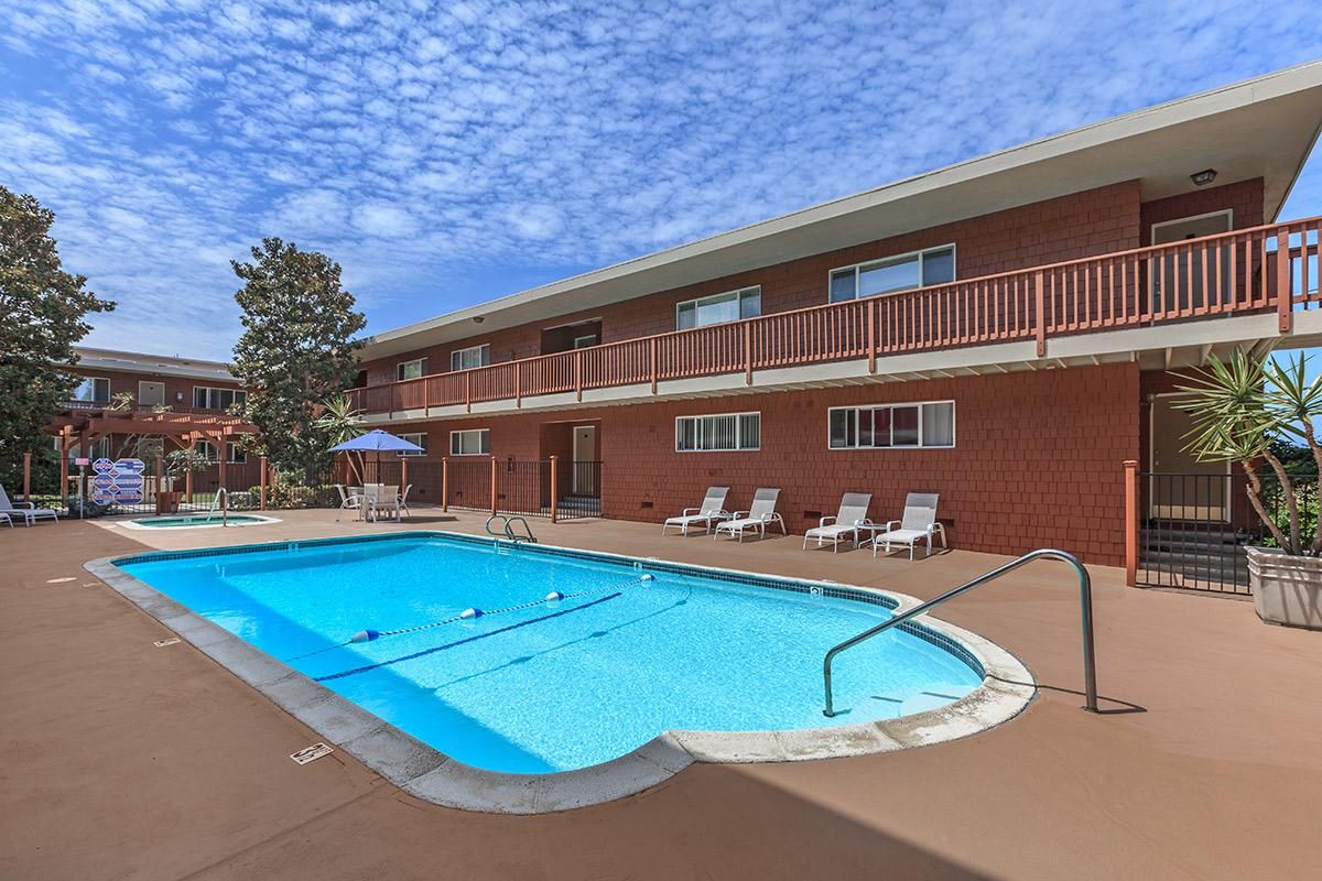 a blue pool of water in front of a building