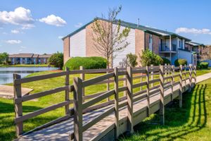 A bridge across the lawn at Port Crossing Apartments in Portage, Indiana