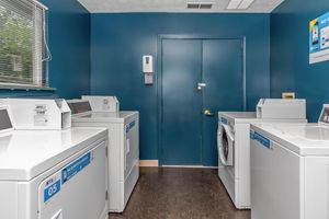 Laundry room with machines and dryers at Port Crossing Apartments in Portage, Indiana