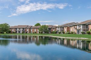 Apartment exteriors around a lake at Port Crossing Apartments in Portage, Indiana