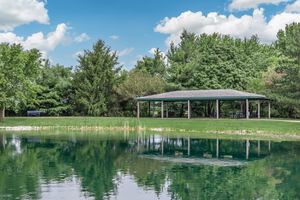 Pergola next to a lake at Port Crossing Apartments in Portage, Indiana