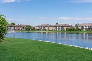 Apartment exteriors around a lake at Port Crossing Apartments in Portage, Indiana