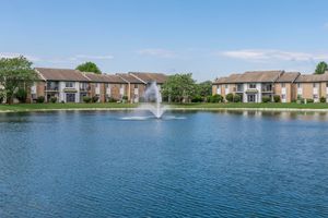 Apartment exteriors around a lake at Port Crossing Apartments in Portage, Indiana