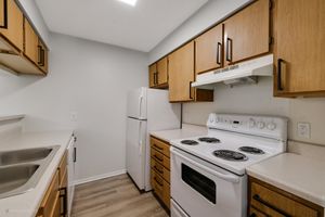 a stove top oven sitting inside of a kitchen