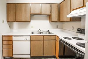 a stove top oven sitting inside of a kitchen