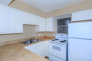 a kitchen with a stove top oven sitting inside of a refrigerator