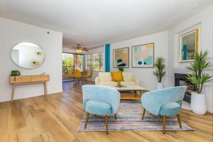 a living room filled with furniture and a lamp