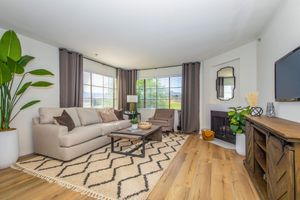 a living room filled with furniture and a large window