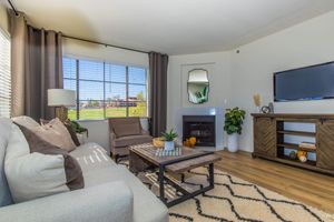 a living room filled with furniture and a flat screen tv