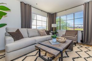 a living room filled with furniture and a large window