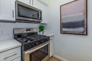 a stove top oven sitting inside of a kitchen