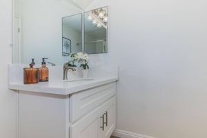 a kitchen with a sink and a mirror