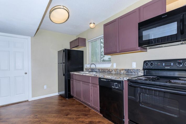 a kitchen with a stove top oven